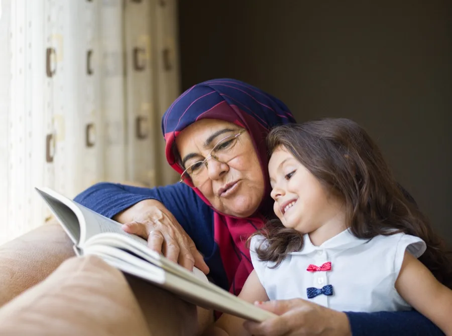 Grandmother reading with her granddaughter